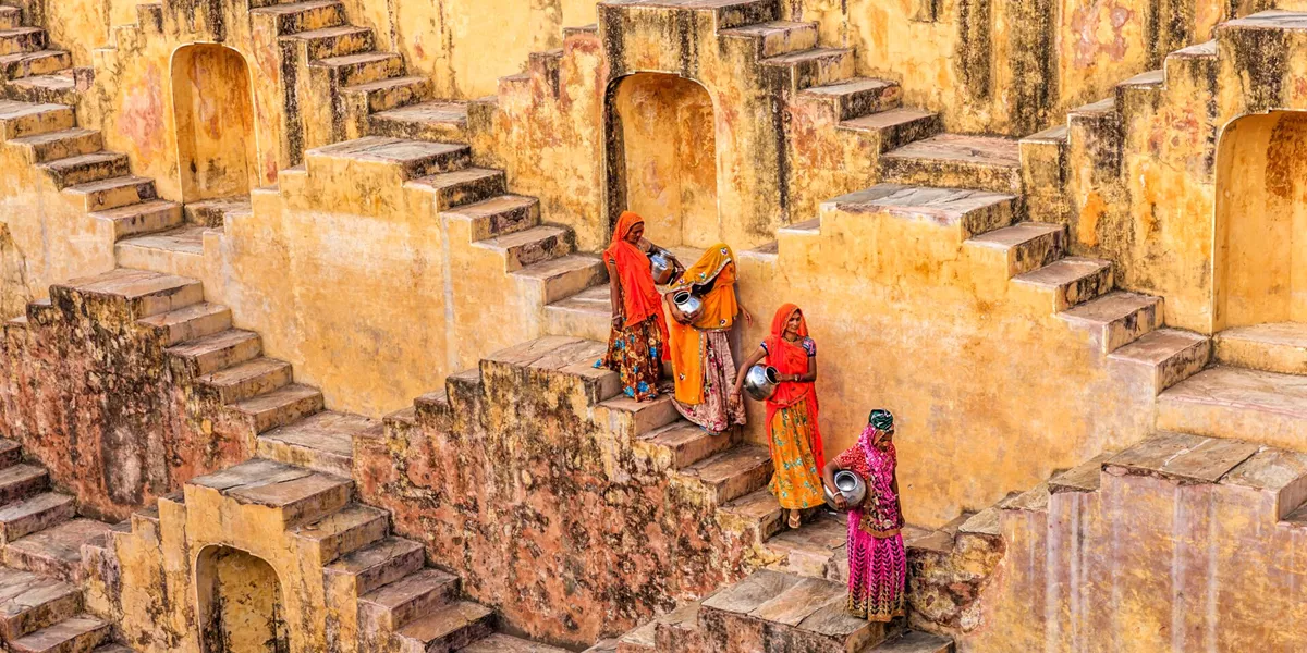 Indian Women Carrying Water From Stepwell Near Jaipur in India