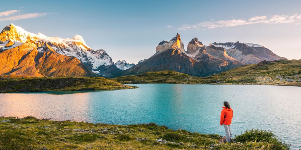 Tourist Admiring The Cordillera Paine In Torres Del Paine National Park