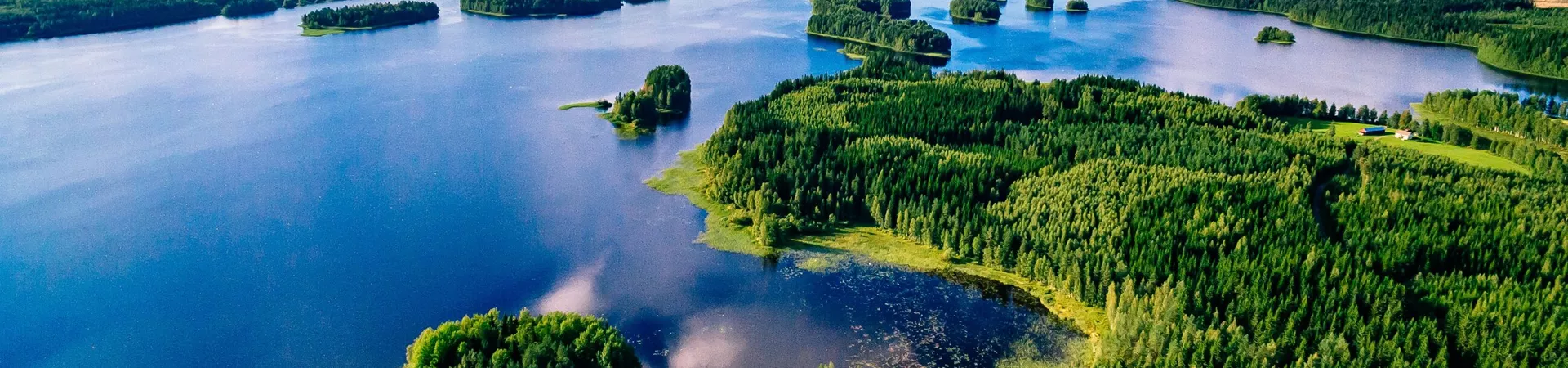 Aerial view of blue lakes and green forests on a sunny summer day in Finland, Europe
