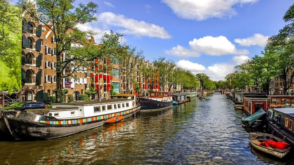 colourful canal boats Amsterdam Netherlands