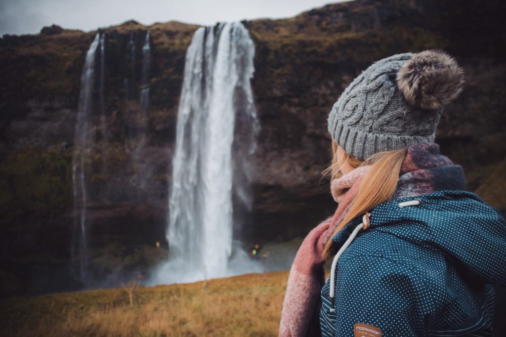 Lady exploring waterfalls in Iceland