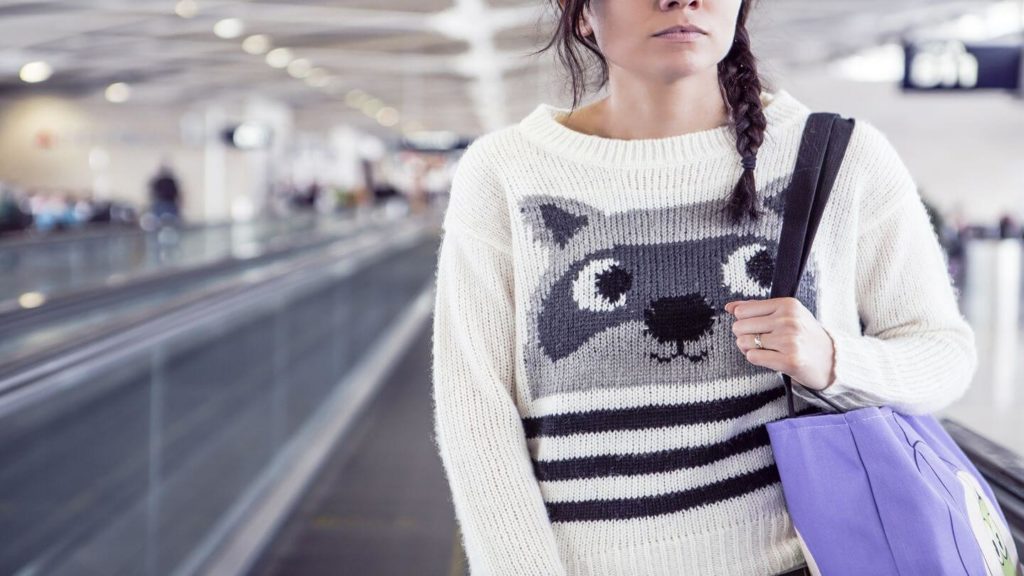 woman wearing warm jumper in airport