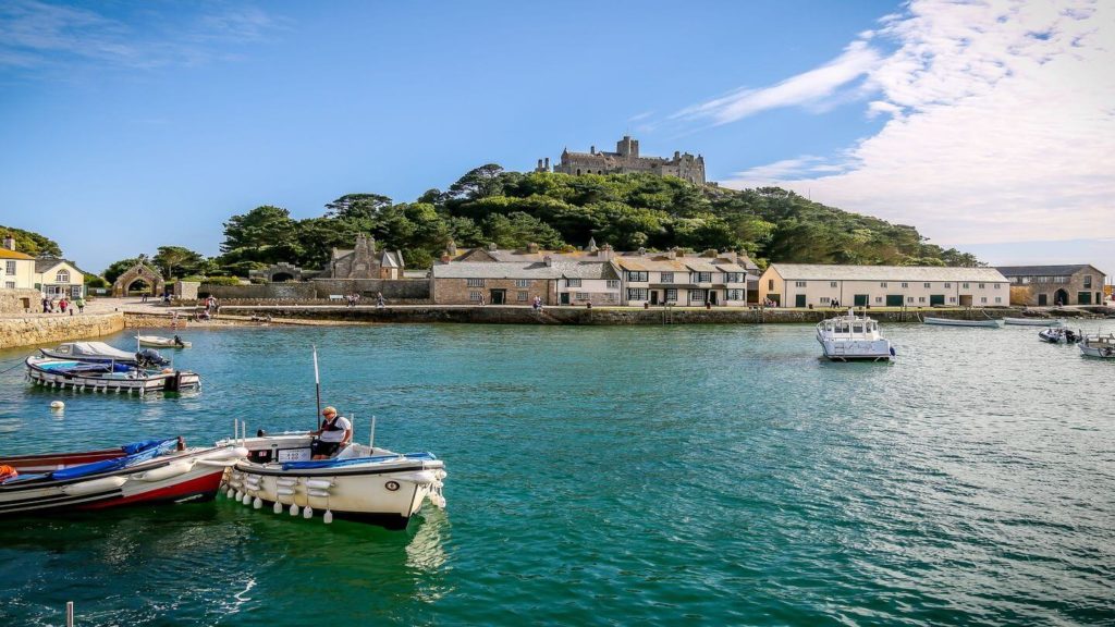 st michaels mount surrounded by blue water and boats St Ives England