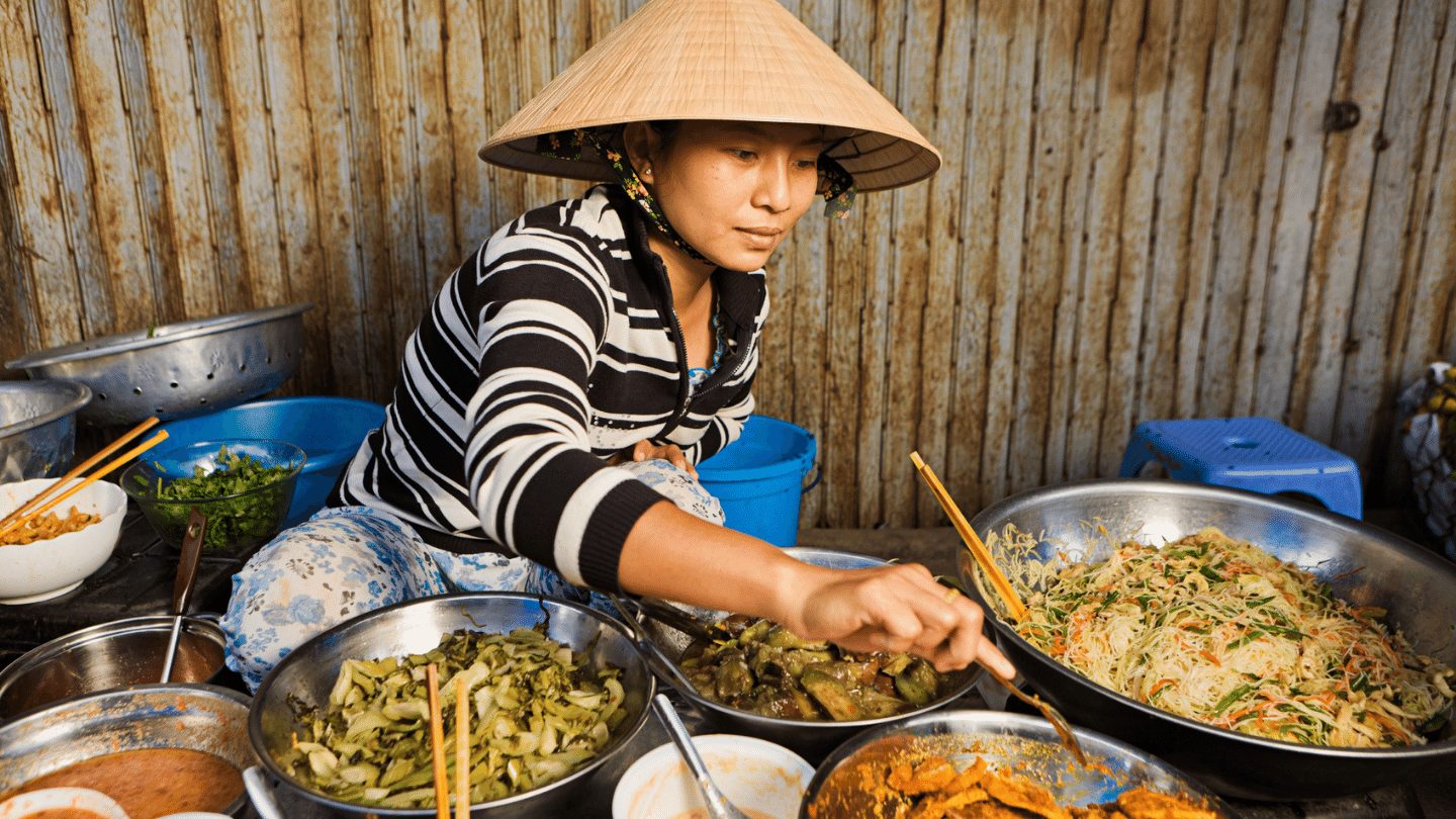 Vietnamese street food served by Vietnamese woman