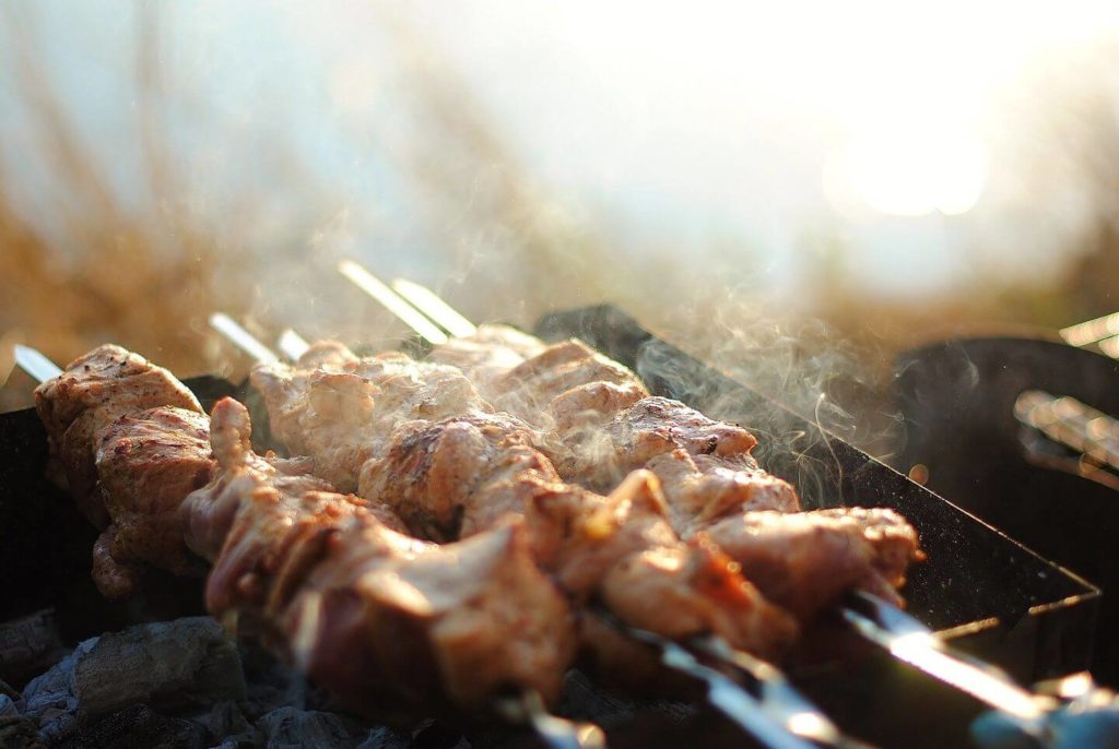 meat skewers on a smoky grill food in Tanzania