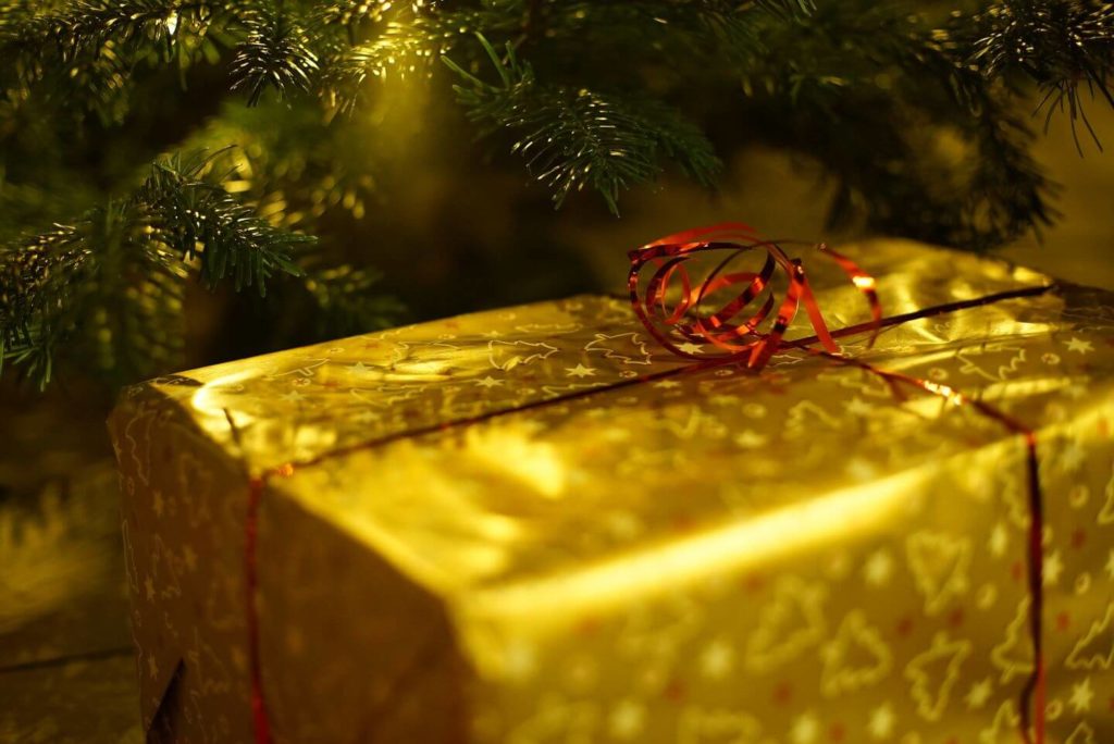 present in gold wrapping under the Christmas tree