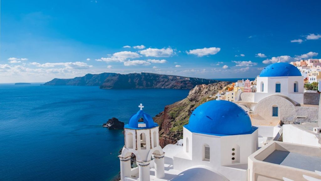 blue domes whitewashed buildings blue ocean Santorini Greek islands