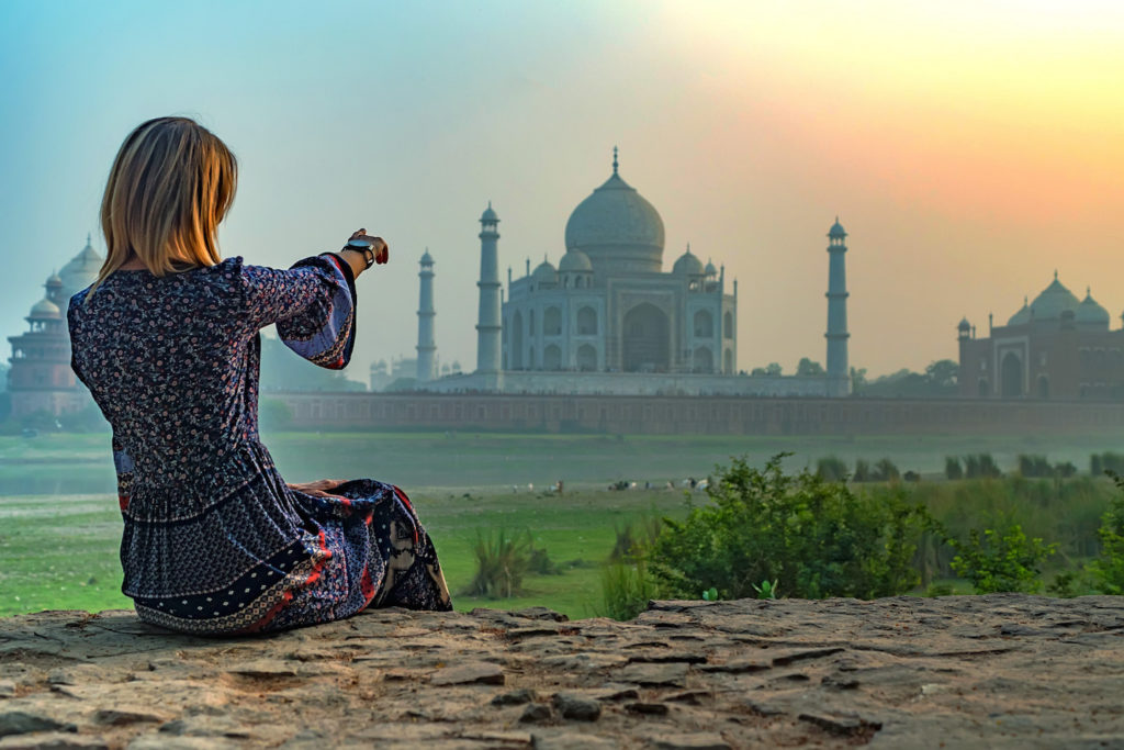 woman looking at the taj mahal