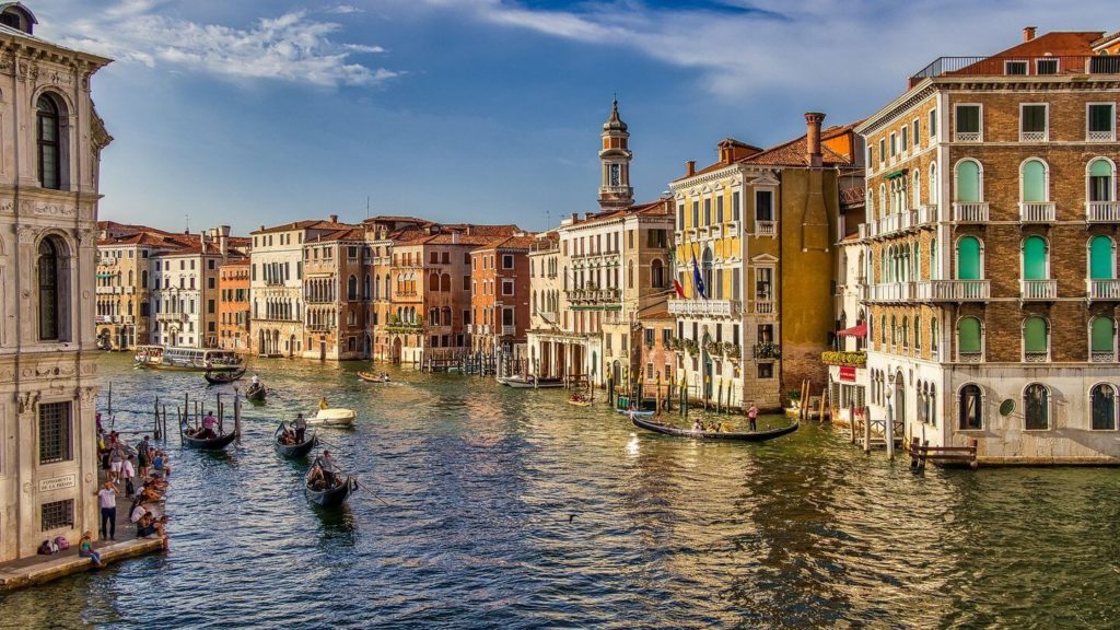 Venice canal gondolas travelling to Italy