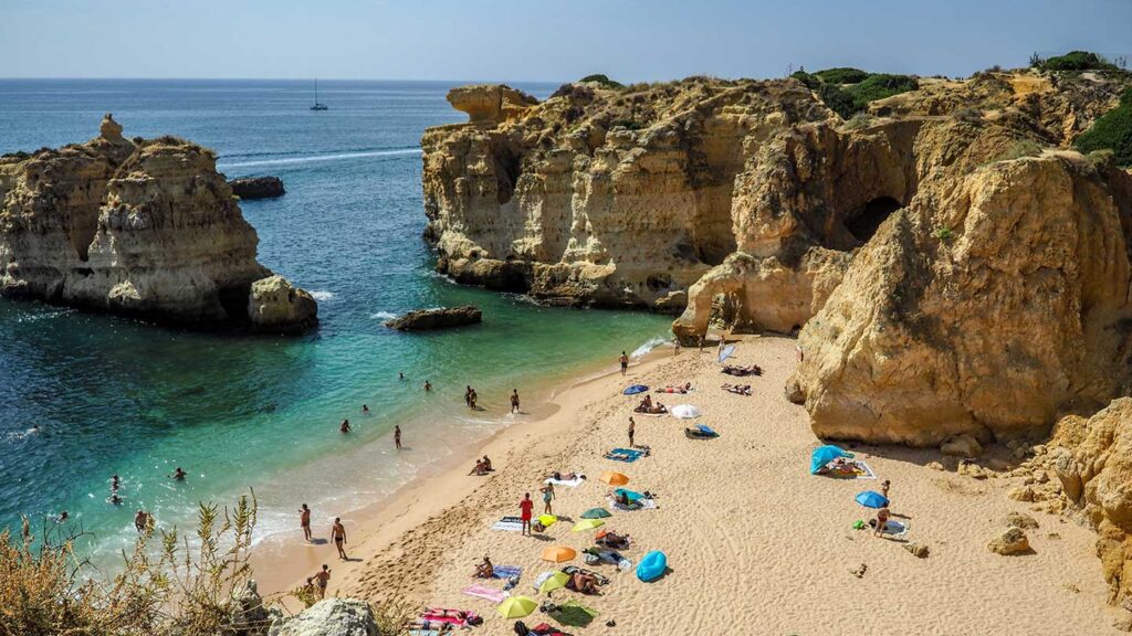Photo of a beach on the Algarve coast, surrounded by cliffs