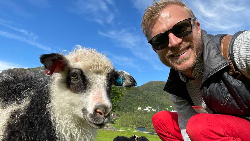 Travel Director Lasse with a sheep in NOrway