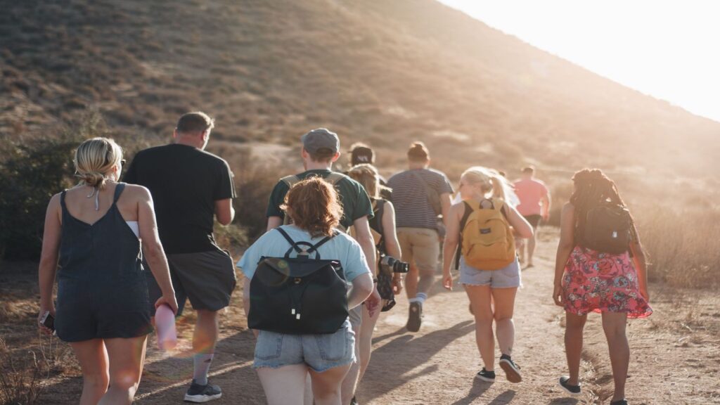 group of people hiking on a mountain trail
