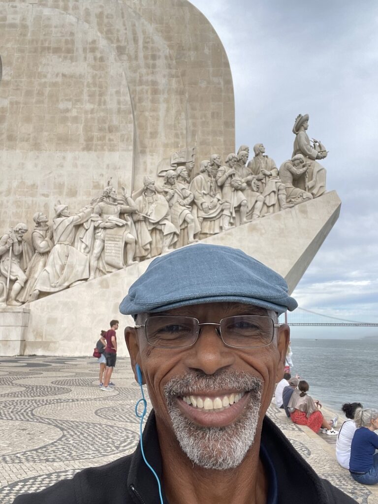 A selfie of Lawrence on his Spain and Portugal trip - behind is a sculpture fresco that overlooks the ocean