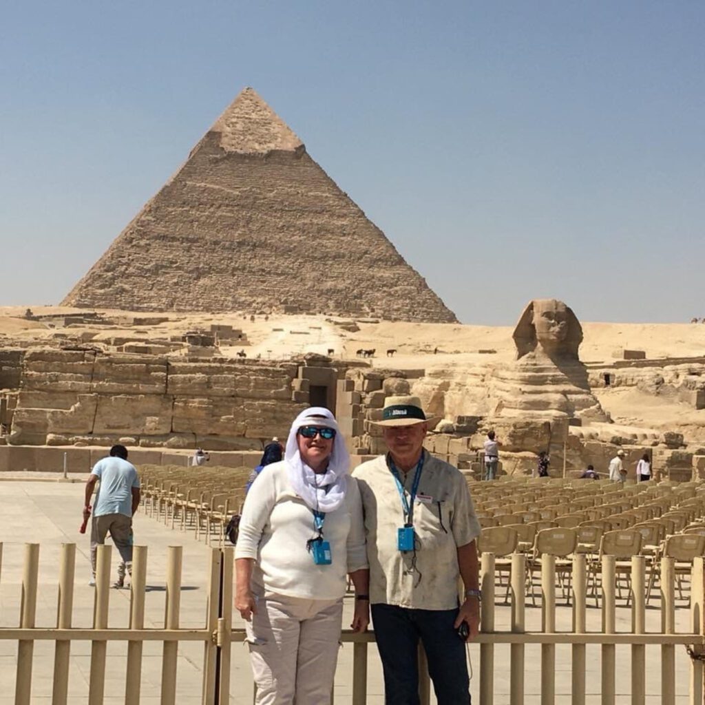 Trafalgar guests Cyndee and her husband at the Great Pyramids of Giza in Egypt