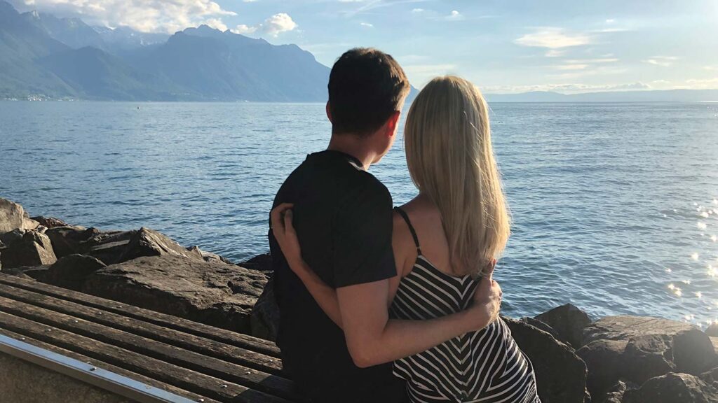 From-behind photo of Ashlinn and her husband looking out over Lake Maggiore, Switzerland
