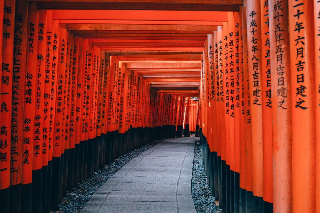 orange torii gates at a temple in Japan