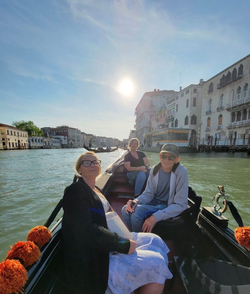 Family posing for photo on a gondola  in Venice