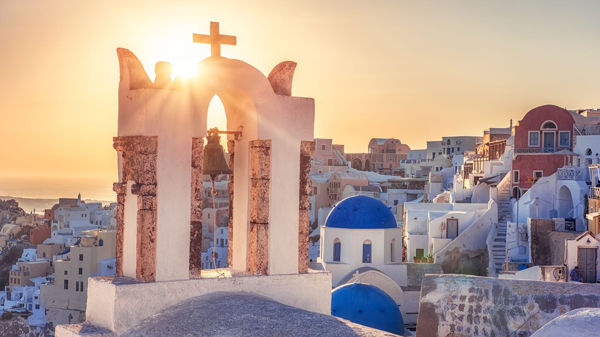 Golden sunset behind church, Santorini, Greece