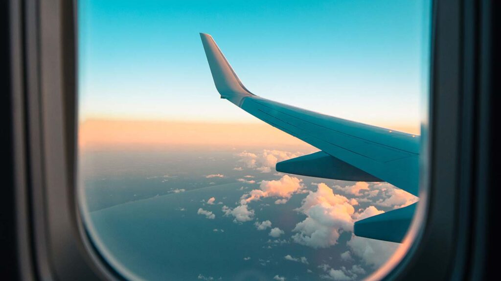 Plane window at sunrise