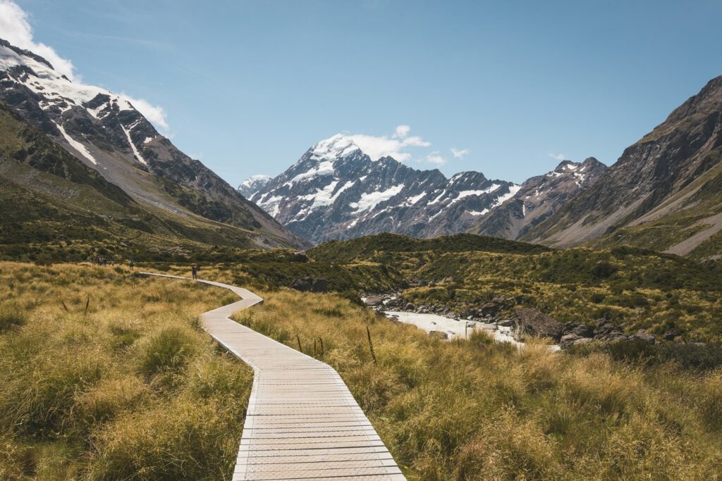 wooden walkway winding through the grassland and mountains New Zealand