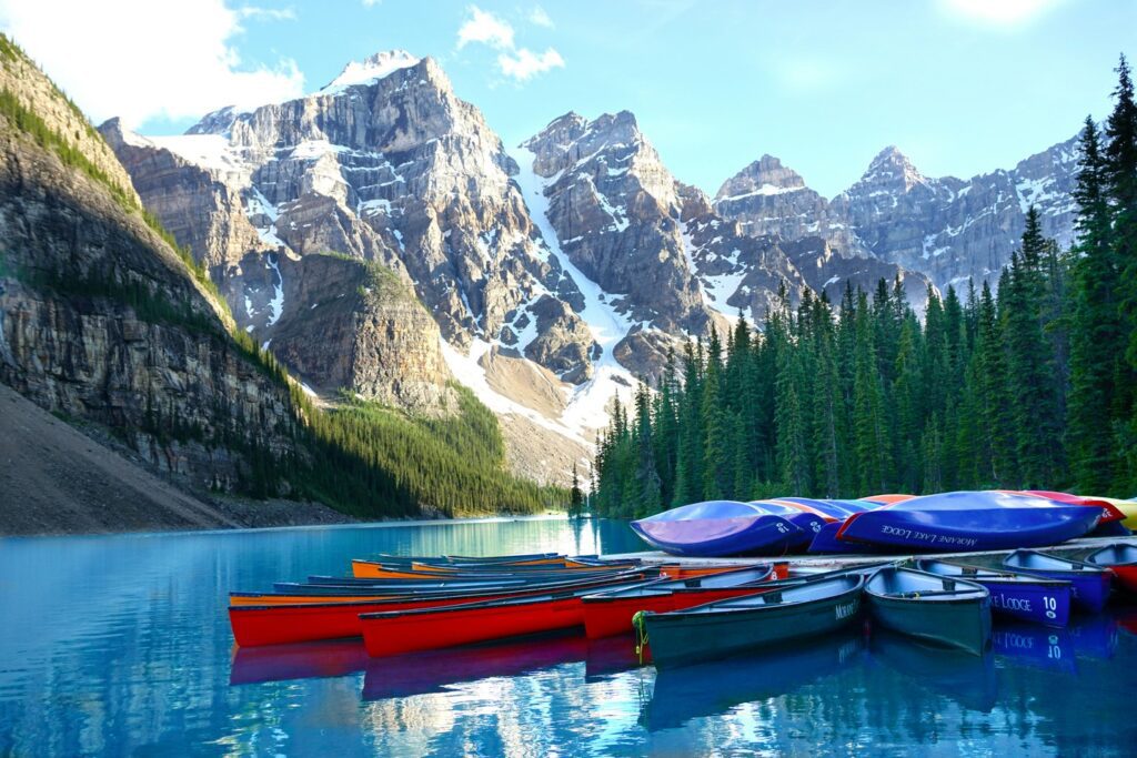 rocky mountains blue lake colorful canoes Banff Canada 