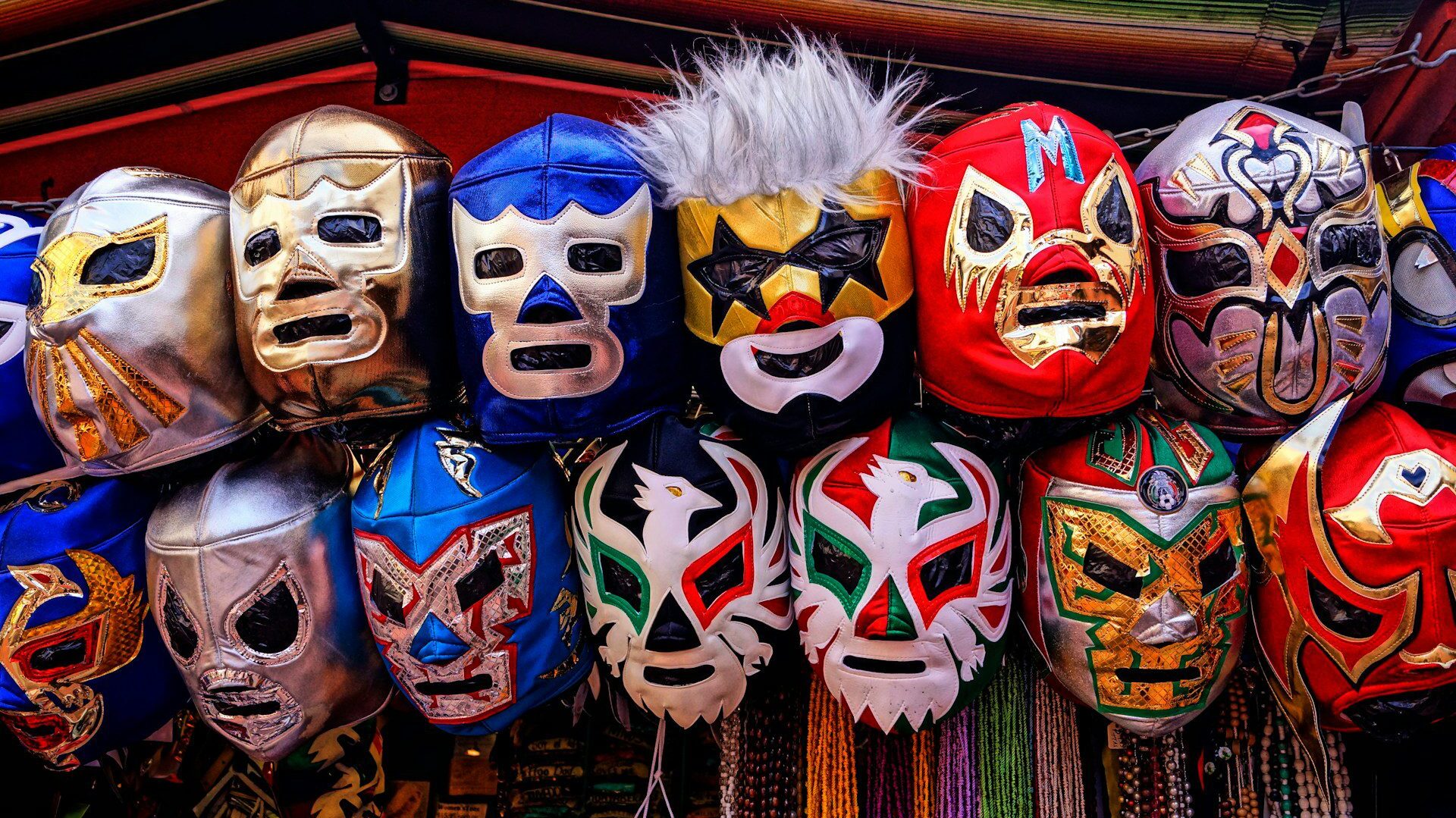 Various Lucha libre wrestling masks hanging up outside a market stall