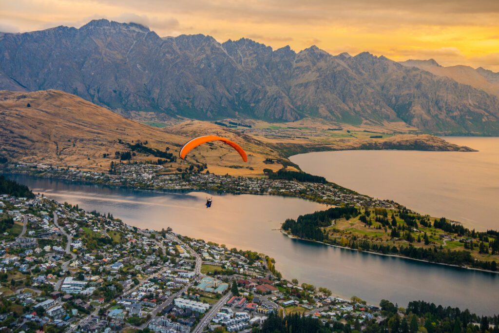 paragliding over Queenstown at sunset New Zealand