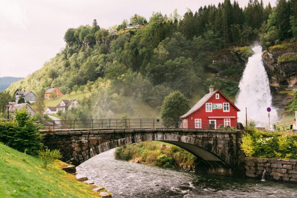 red cottage rushing river Norwegian village