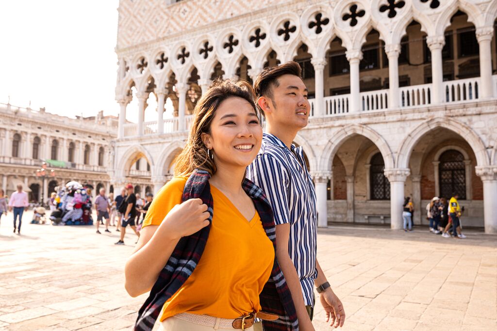 Asian couple walking in St Mark's Square, Venice